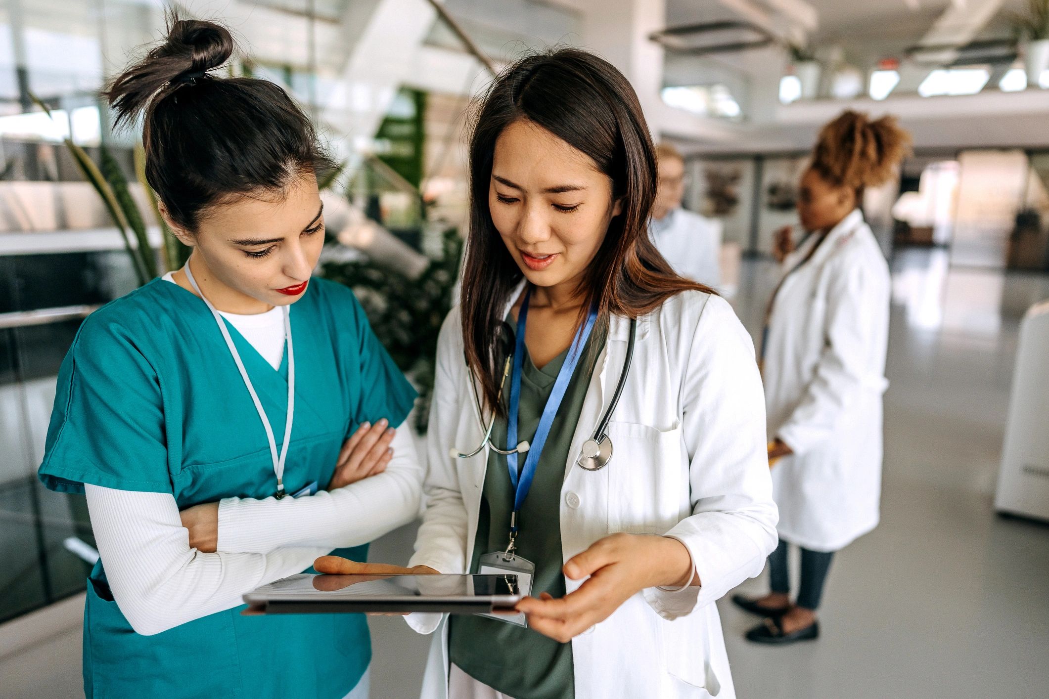 Two doctors discussing mentorship and guidance in a hospital corridor