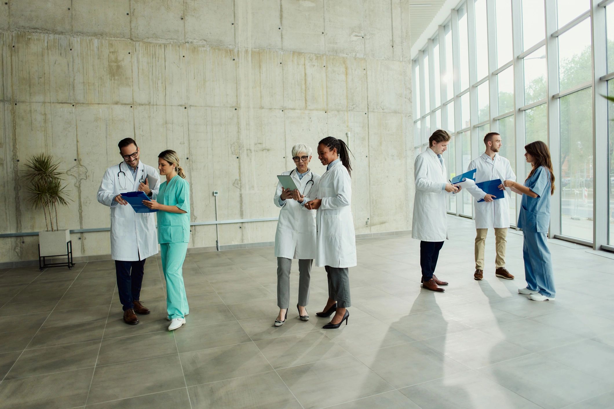 Group of doctors collaborating in a hospital hallway