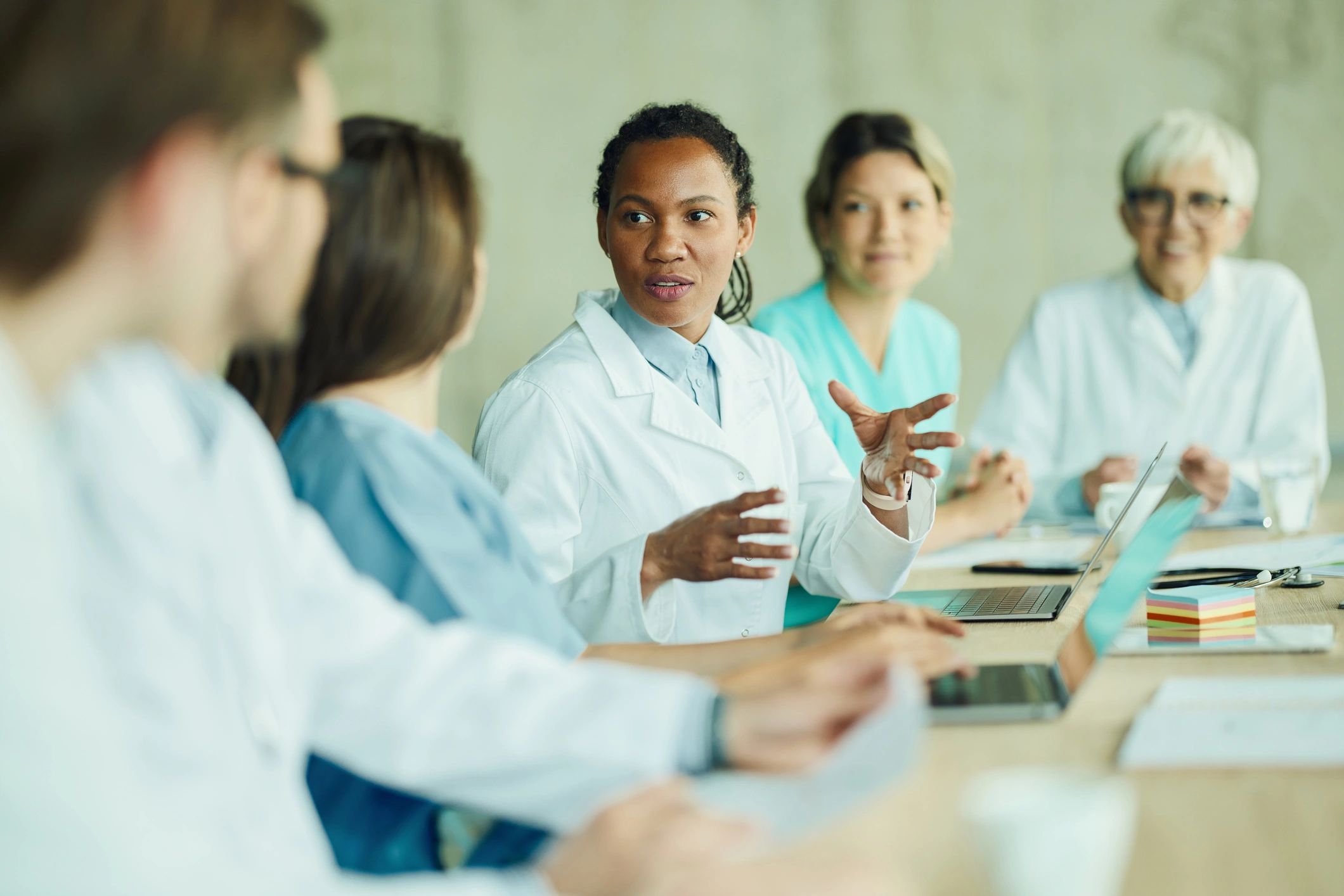 Doctor speaking with colleagues during a meeting