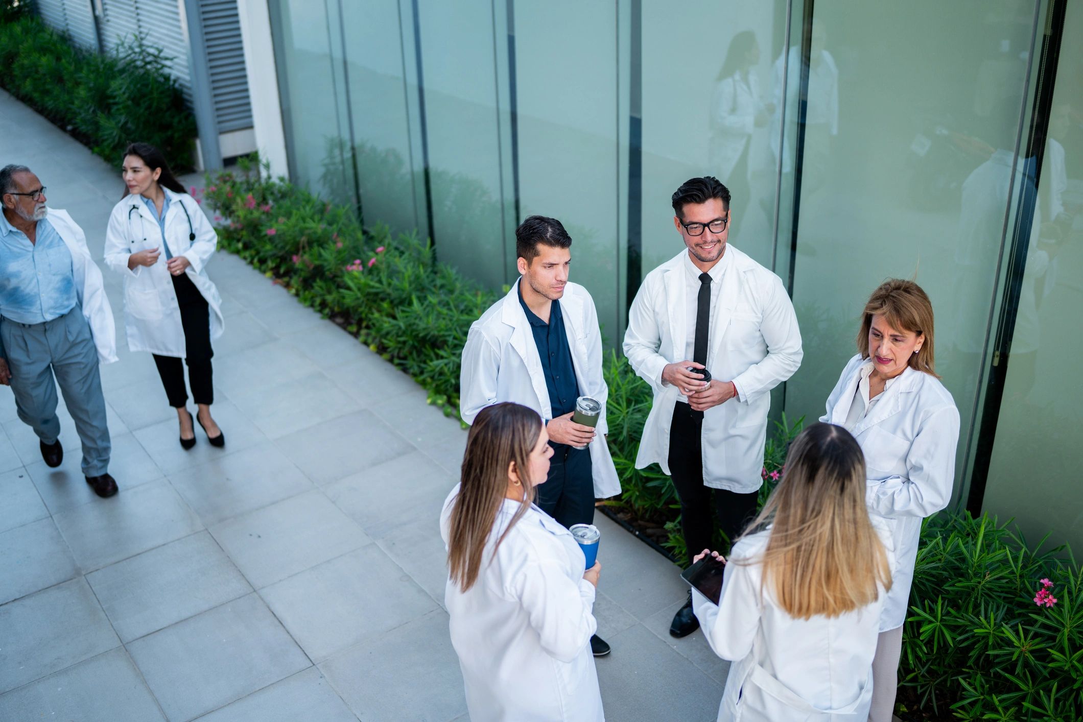 Doctors networking and talking outdoors