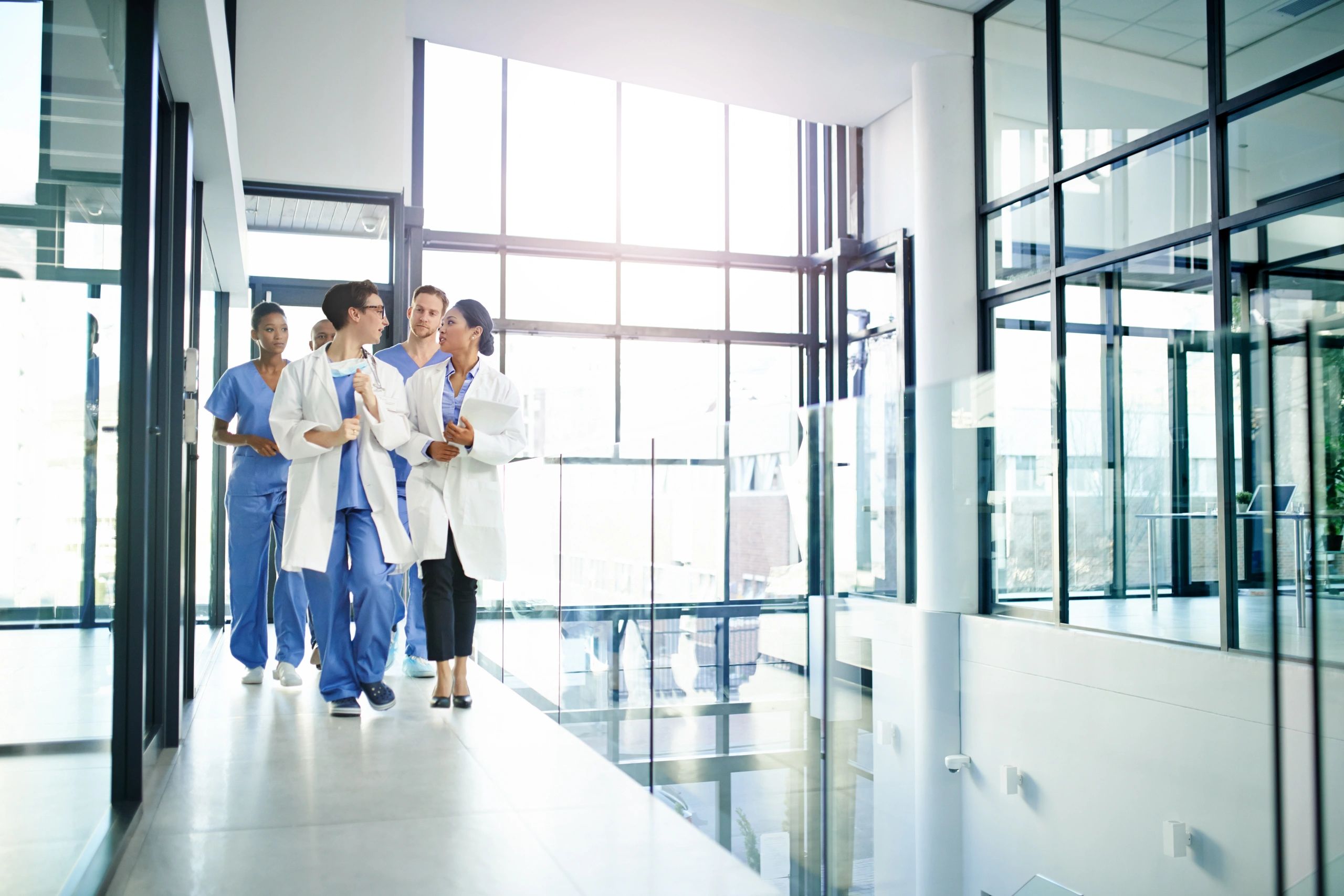 Doctors walking and discussing a patient file in a medical center